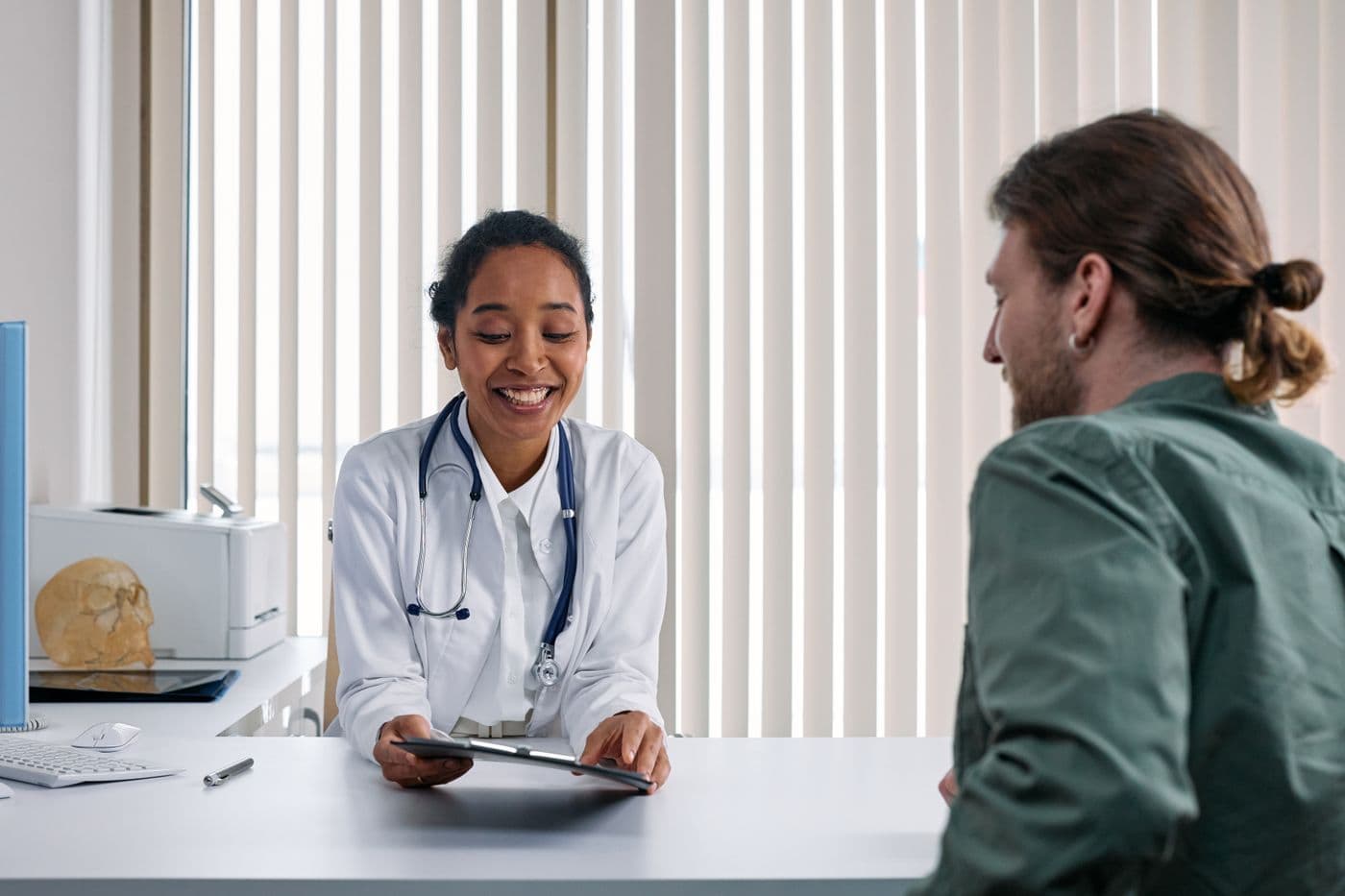 Doctor reviewing a patient record with a patient
