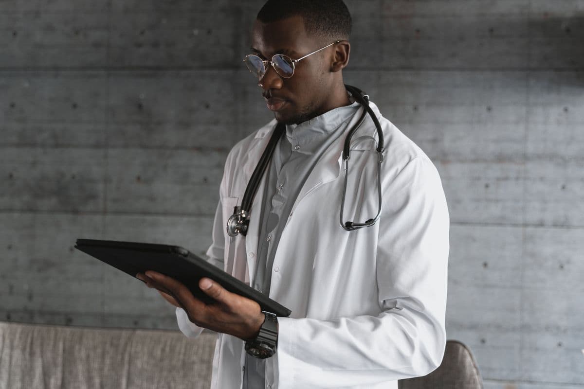 Doctor reviewing a patient record on a tablet