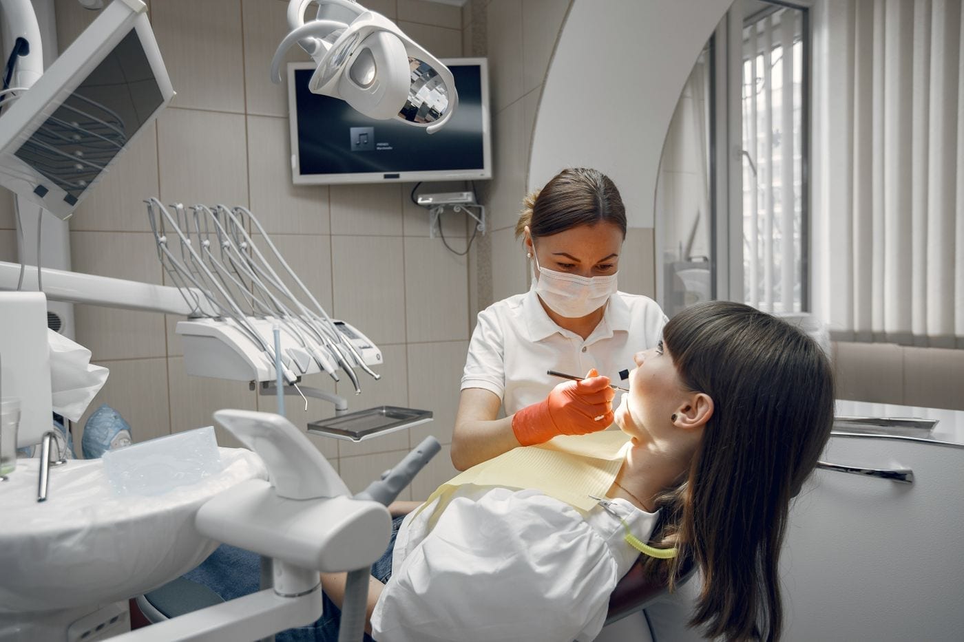 Dentist examining a patient in a bright dental clinic