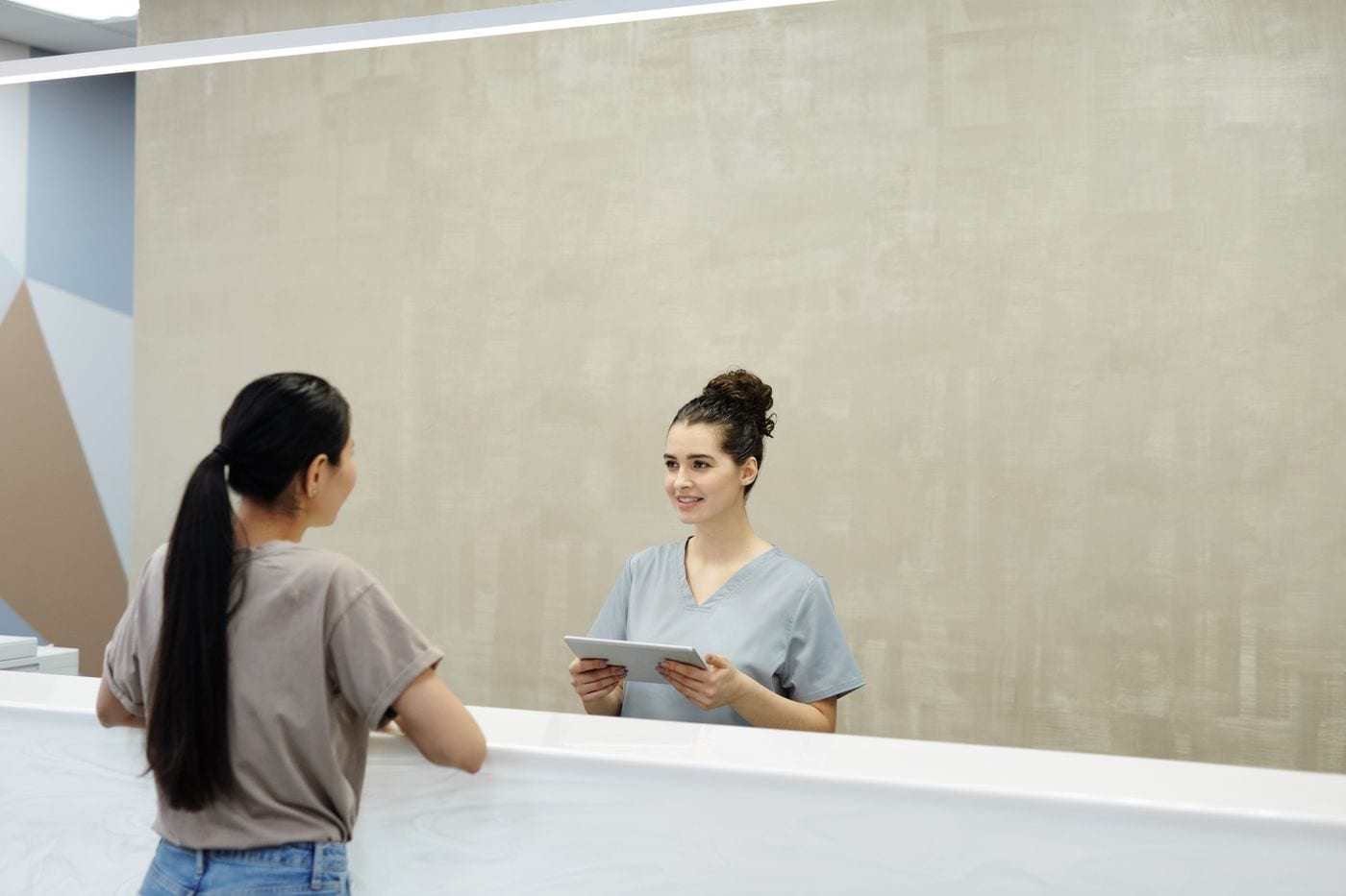 Front desk team member welcoming a patient