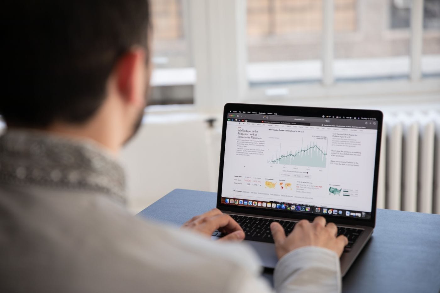 Practice manager reviewing reports on a laptop