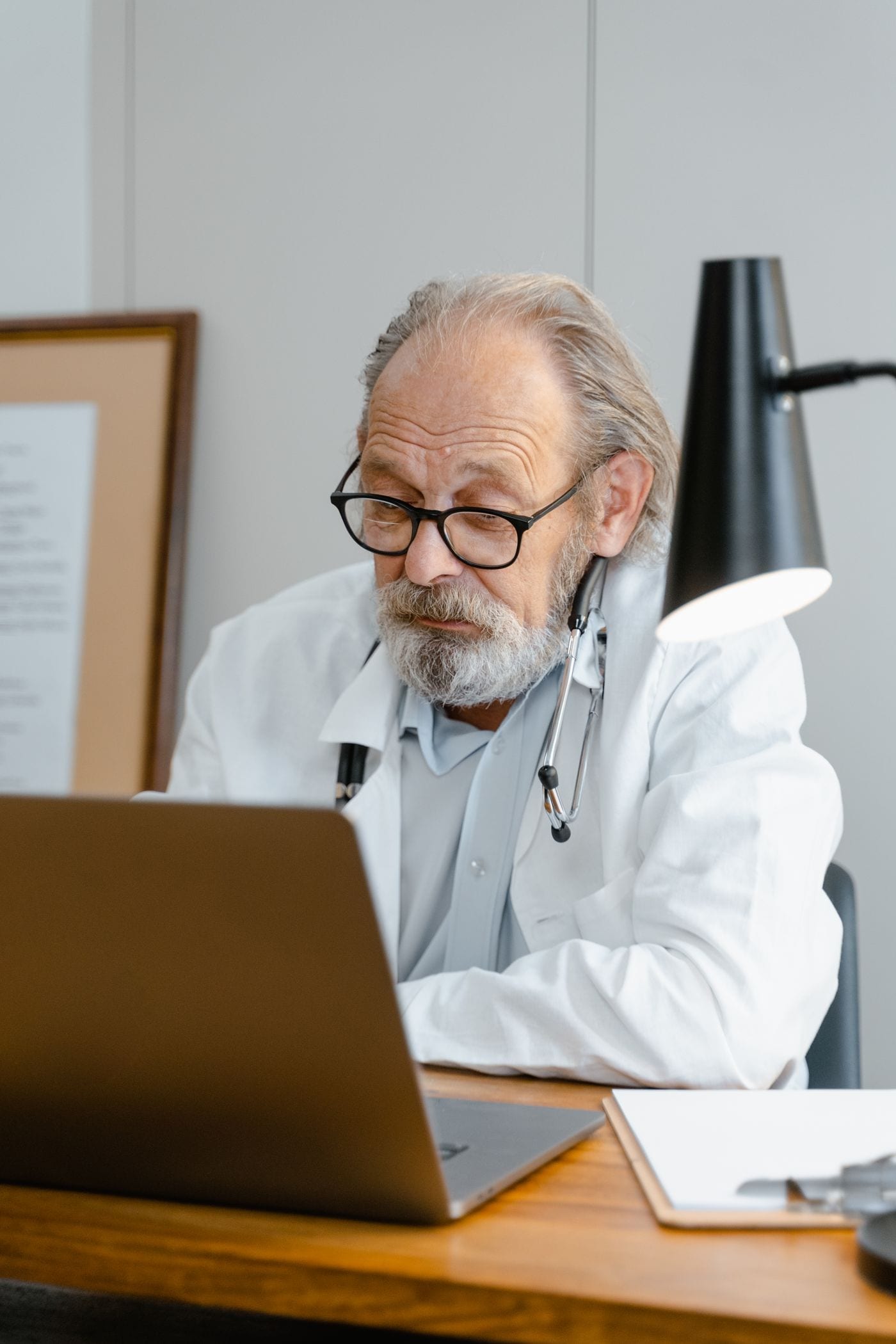 Doctor reviewing patient records on a laptop